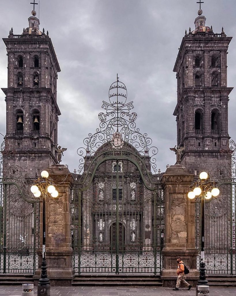 Outside of the Zócalo de Puebla. The church has two large church towers with bells.