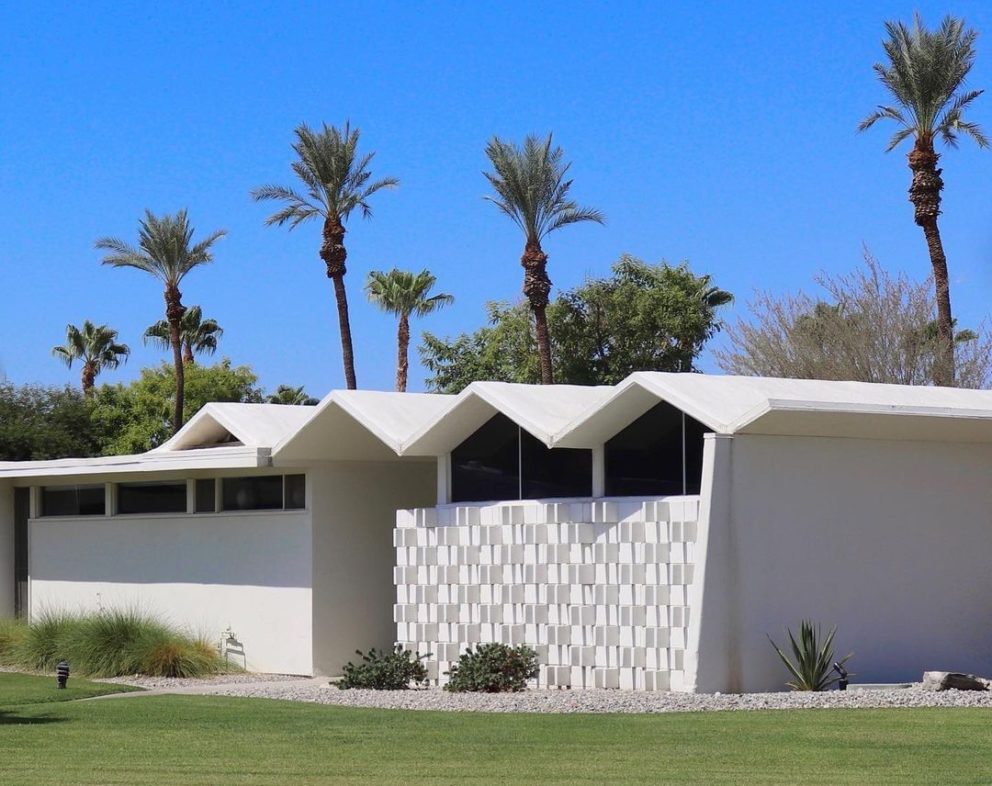White, modern-styled building in Palm Springs. The building has a roof that has many peaks.