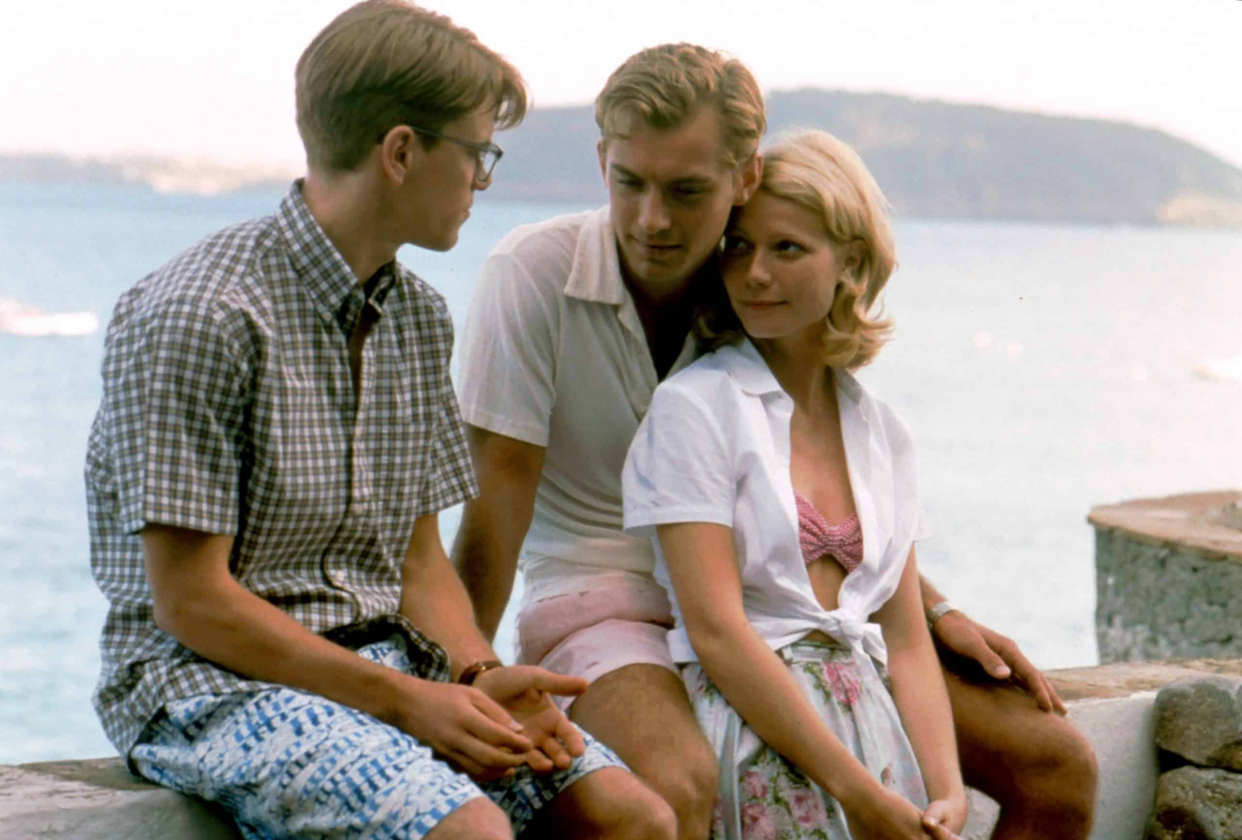 Scene from The Talented Mr. Ripley with Matt Damon, Jude Law, and Gwyneth Paltrow are sitting on a rock wall.