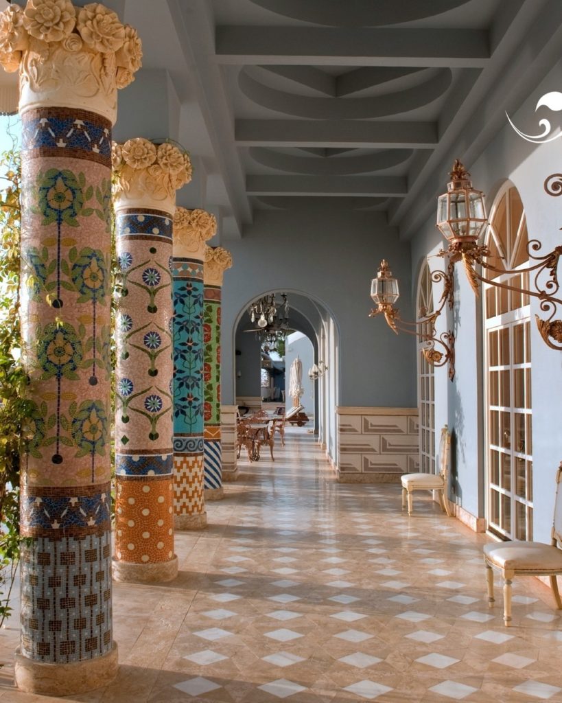 Hotel area in Egypt with a tile floor and different colored columns.
