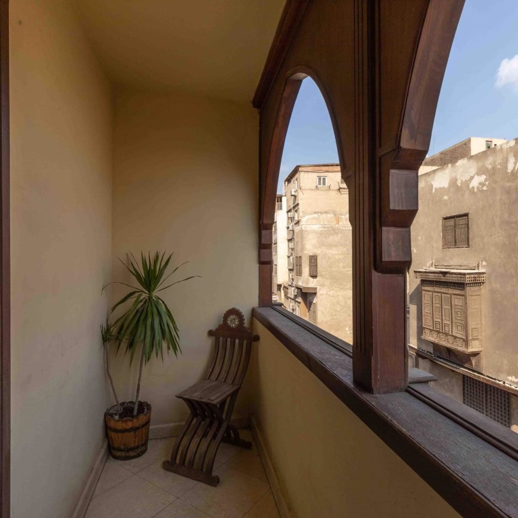 Balcony with curved arches and a view of other buildings in Egypt.