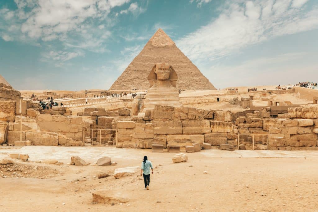 Person walking towards the Pyramids and Sphinx in Egypt.